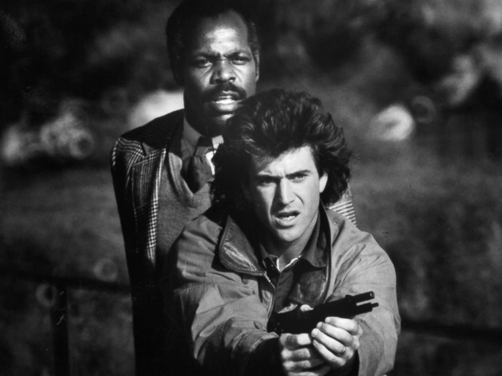 PHOTO: Danny Glover stands behind Mel Gibson in a scene from the film Lethal Weapon, 1987. 