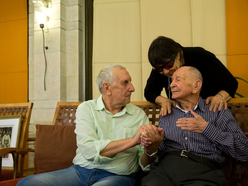 In this Thursday, Nov. 16, 2017 photo, Israeli Holocaust survivor Eliahu Pietruszka, right, speaks with Alexandre Pietruszka as they meet for the first time in the central Israeli city of Kfar Saba. Pietruszka who fled Poland at the beginning of Worl