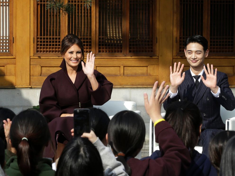 U.S. first lady Melania Trump and Choi Min-ho, a member of South Korean boy band Shinee, wave to South Korean middle school students during Girls Play 2! Initiative.