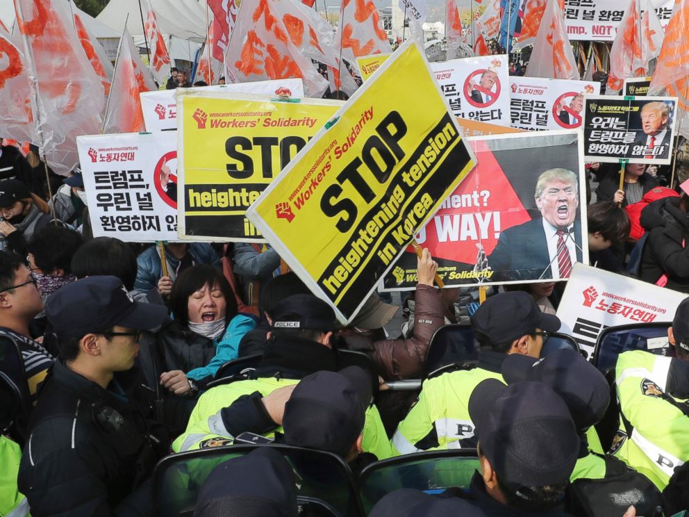 Members of the No Trump Coalition are blocked by police officers during a rally in Seoul, South Korea, Tuesday, Nov. 7, 2017. South Korean police were on high alert in Seoul on Tuesday to monitor protests by both critics and supporters of President D