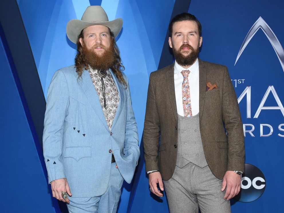 John Osborne, left, and T.J. Osborne, of Brothers Osborne, arrive at the 51st annual CMA Awards on Wednesday, Nov. 8, 2017, in Nashville, Tenn. 