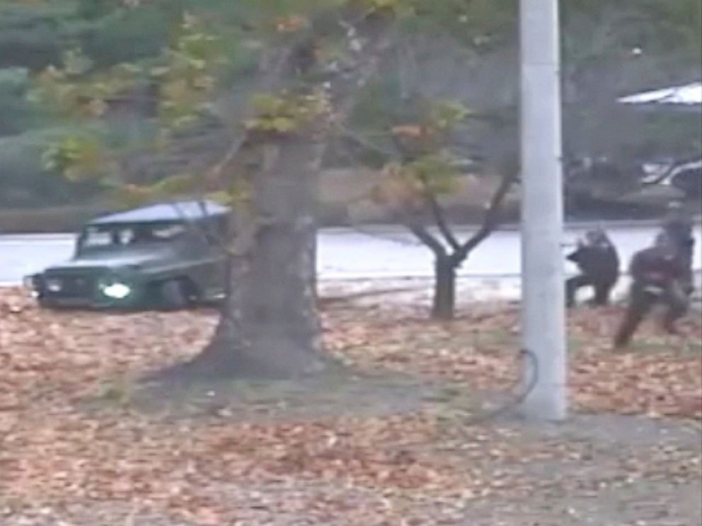 This image made from Nov. 13, 2017 surveillance video released by the United Nations Command shows a North Korean soldier running from a jeep and later shot by North Korean soldiers in Panmunjom, North Korea.