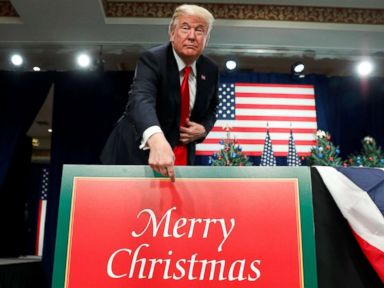 PHOTO: President Donald Trump points to a Merry Christmas placard on the stage as he arrives to deliver remarks on tax reform in St. Louis, Mo., Nov. 29, 2017.