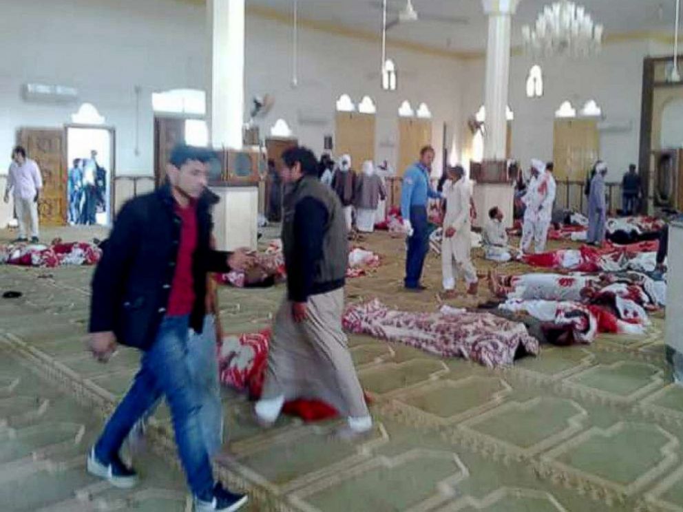 PHOTO: People stand over bodies of worshipers killed in attack on mosque in the northern city of Arish, Sinai Peninsula, Egypt, Nov. 24, 2017.