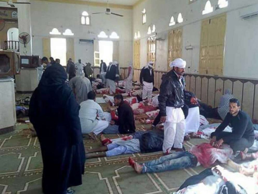 PHOTO: People sit next to bodies of worshipers killed in attack on mosque in the northern city of Arish, Sinai Peninsula, Egypt, Nov. 24, 2017.