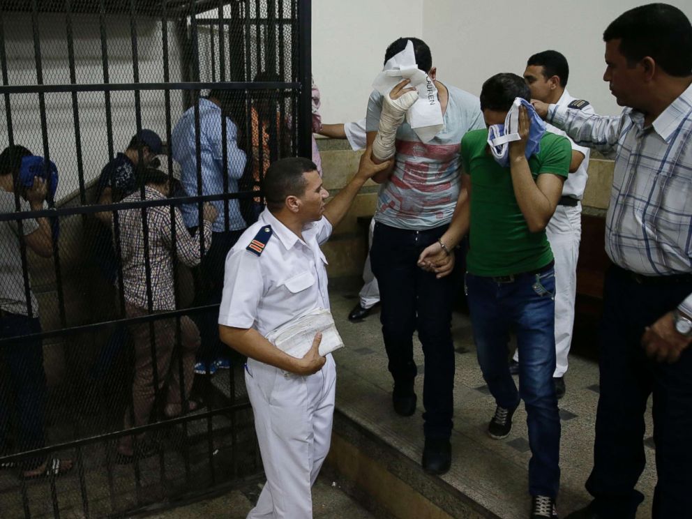 PHOTO: Eight Egyptian men convicted for inciting debauchery following their appearance in a video of an alleged same-sex wedding party on a Nile boat leave the defendants cage in a courtroom in Cairo, Egypt, Nov. 1, 2014. 