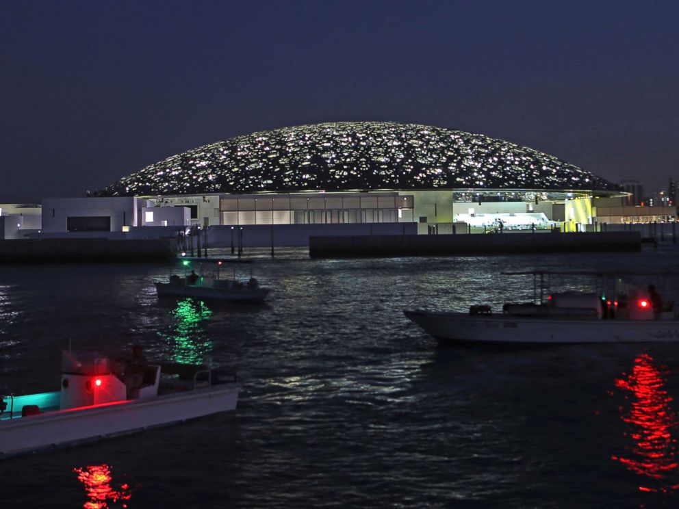 PHOTO: Boat lights are reflected on the water in front of the Louvre Abu Dhabi, Nov. 6, 2017. 