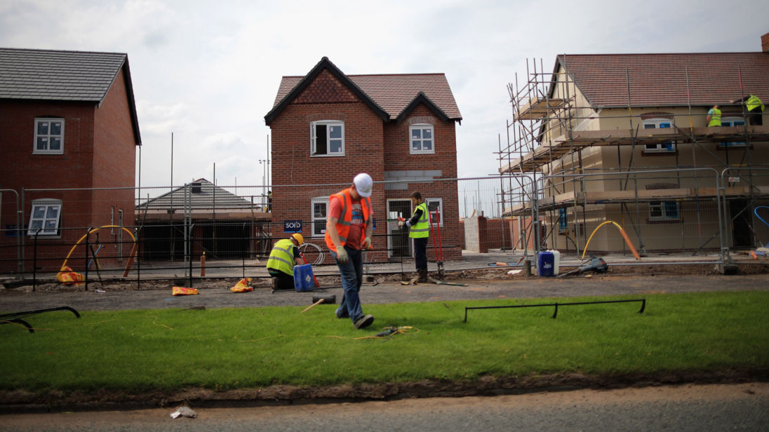 MIDDLEWICH, ENGLAND - MAY 20:  Construction workers build new houses on a housing development on May 20, 2014 in Middlewich, England. Official figures have shown that house prices have risen by 8% in the year ending in March. There have been calls by some experts for the UK Help to Buy scheme to scaled down as it boosts the property market.  (Photo by Christopher Furlong/Getty Images)