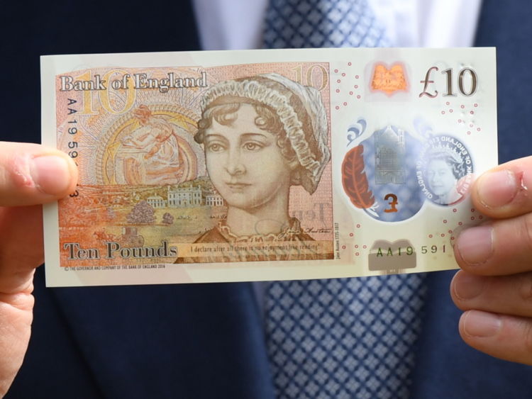The Governor of the Bank of England, Mark Carney, holds the new £10 note featuring Jane Austen, which marks the 200th anniversary of Austen's death, during the unveiling at Winchester Cathedral