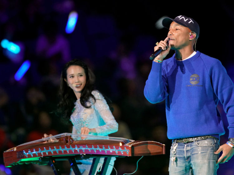 Pharrell Williams performs with Hong Kong singer Karen Mok
