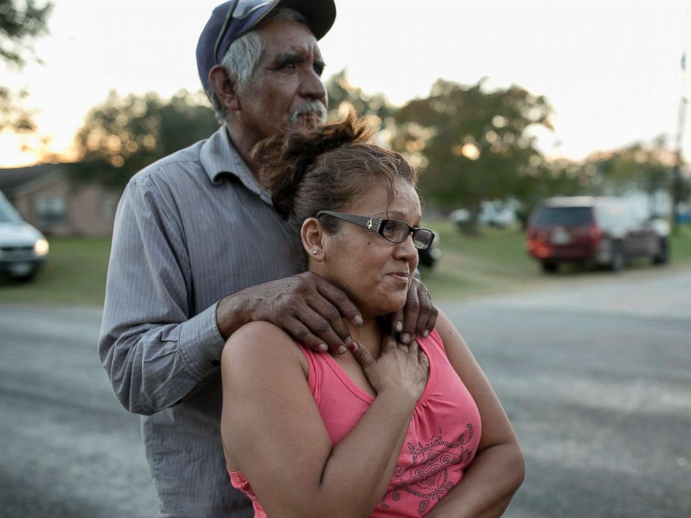 PHOTO: Enrique and Gabby Garcia watch investigators at the scene of a mass shooting at the First Baptist Church in Sutherland Springs, Texas, Nov. 5, 2017.
