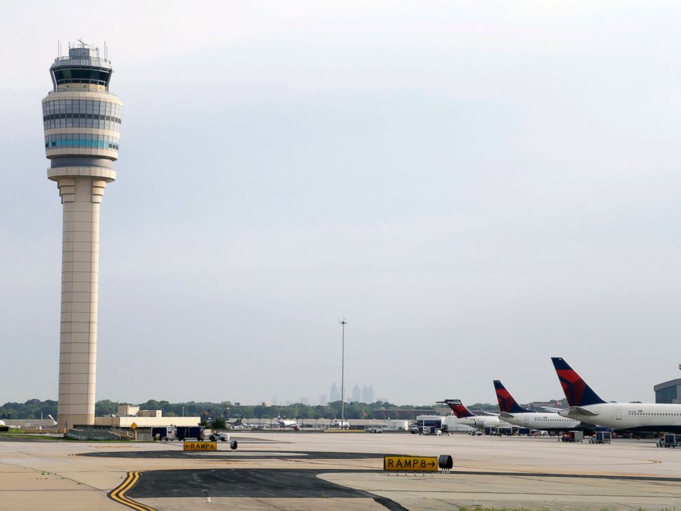 FILE- This May 9, 2016, file photo, shows an air traffic control tower at their gates at Hartsfield–Jackson Atlanta International Airport in Atlanta. Authorities say a power outage at the Hartsfield-Jackson Atlanta International Airport has disrupted