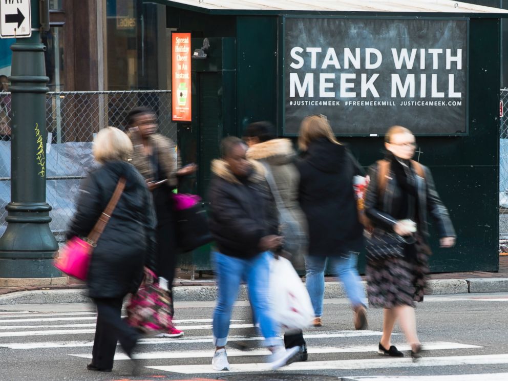 People walk past a placard posted on a newsstand with a message of support for imprisoned rapper Meek Mill, in Philadelphia, Friday, Dec. 1, 2017. Mill’s imprisonment on a probation violation has set off a flurry of legal appeals, criticism of the cr