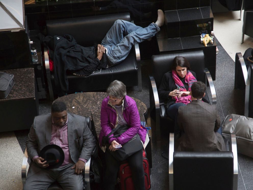 Passengers wait for the lights to come back on at Hartsfield-Jackson International Airport, Sunday, Dec. 17, 2017, in Atlanta. A sudden power outage at the Hartsfield-Jackson Atlanta International Airport on Sunday grounded scores of flights and pass