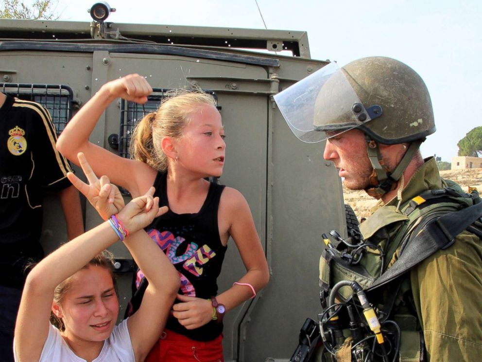 PHOTO: A file photo from Nov.2, 2012 shows Palestinian girl Ahed al-Tamimi (C) challenging Israeli soldiers during a protest in Ramallah, West Bank. 