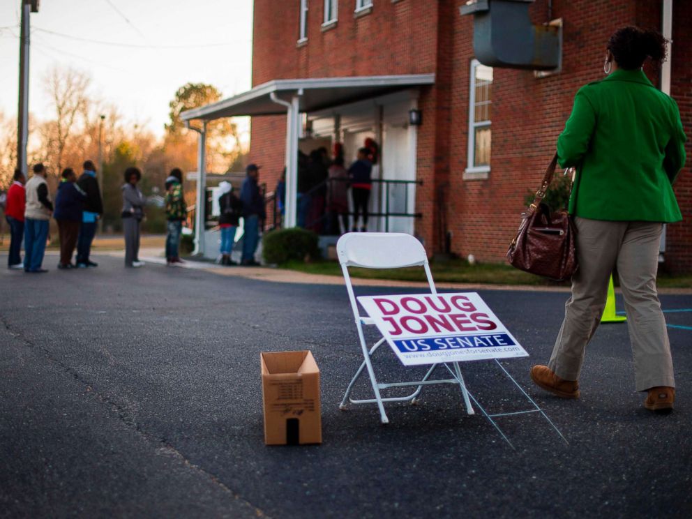 PHOTO: A woman walks over to get in line to vote at Beulah Baptist Church polling station in Montgomery, Ala. on Dec. 12, 2017.