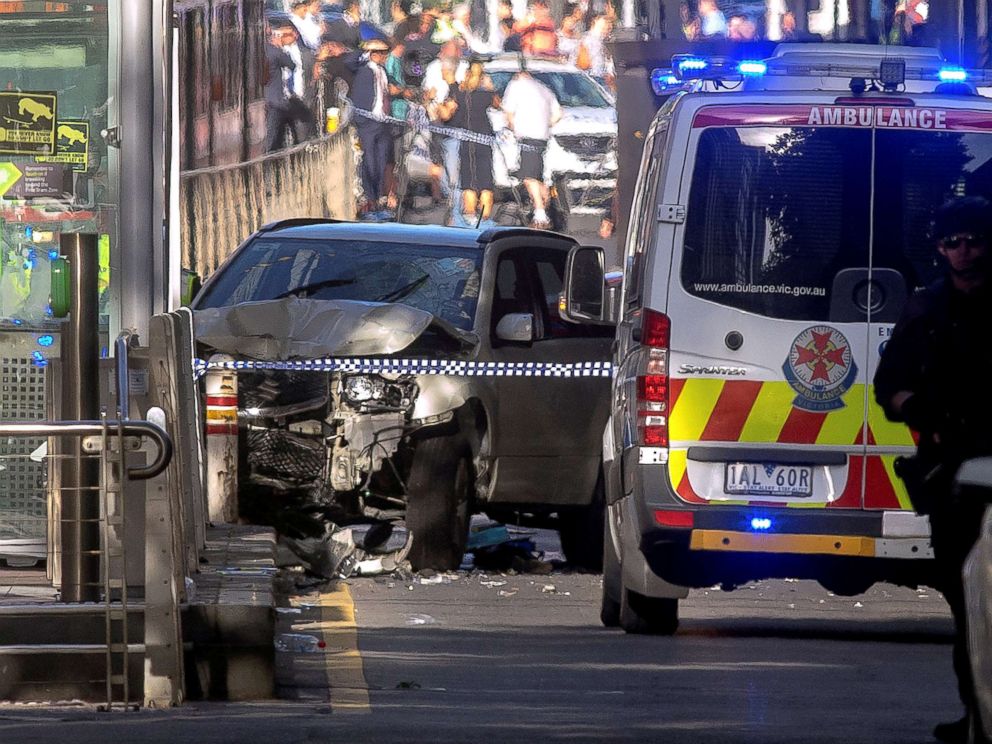PHOTO: Australian police stand near a crashed vehicle after they arrested the driver of a vehicle that had rammed into pedestrians at a crowded intersection near the Flinders Street train station in central Melbourne, Australia, Dec. 21, 2017. 