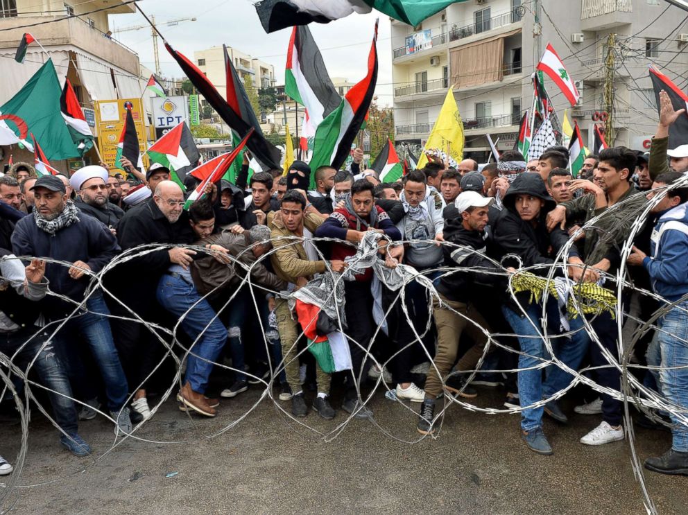 PHOTO: Protesters try to remove barbed wires that block a road near the U.S. embassy during a protest against President Donald Trumps decision to recognize Jerusalem as the Capital of Israel, in Awkar, east of Beirut, Lebanon, Dec. 10, 2017. 