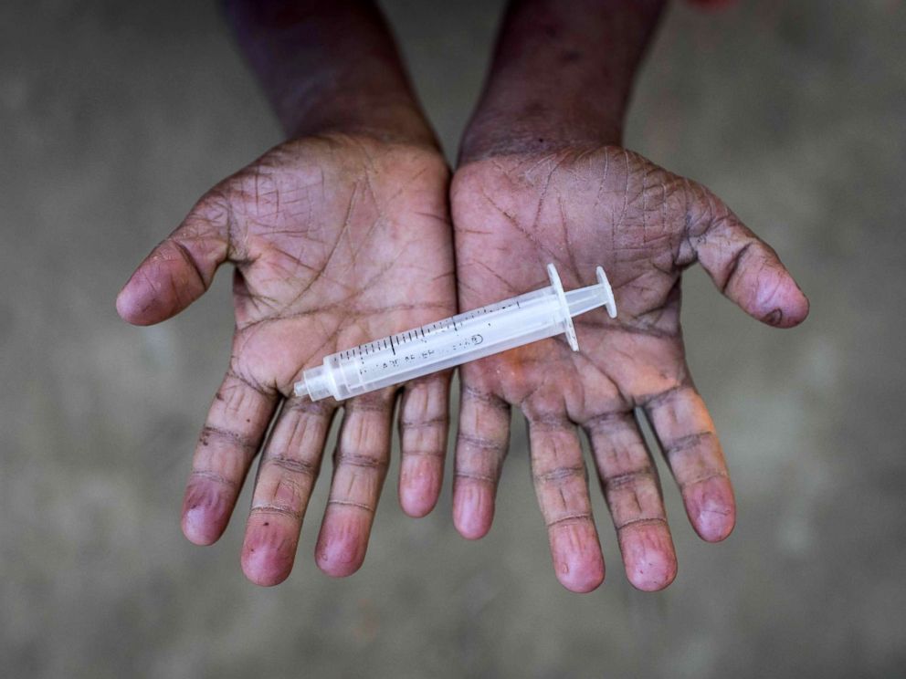 PHOTO: Rohingya migrant boy Mohhamad Hussein (10), who arrived in Bangladesh in October, holds a discarded syringe that he was playing with at the Thankhali refugee camp in Coxs Bazar, Dec. 2, 2017. 