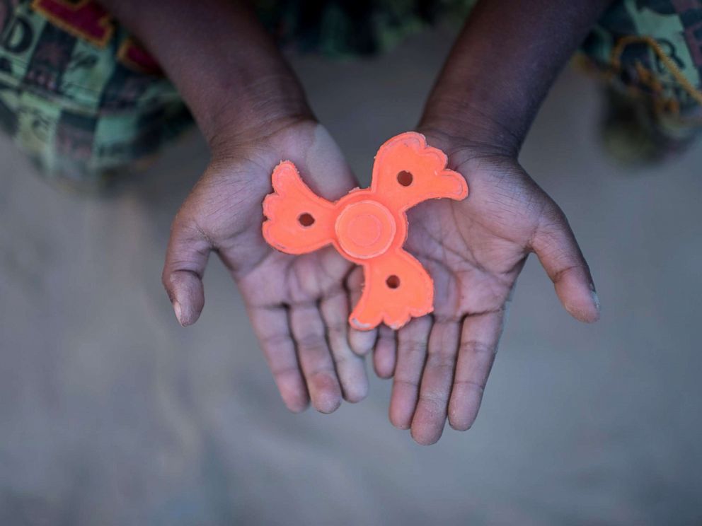 PHOTO: Rohingya migrant boy Mohammad Sadek (5) holds a plastic fidget spinner that he found discarded, at Thankhali refugee camp in Coxs Bazar, Dec. 2, 2017. 
