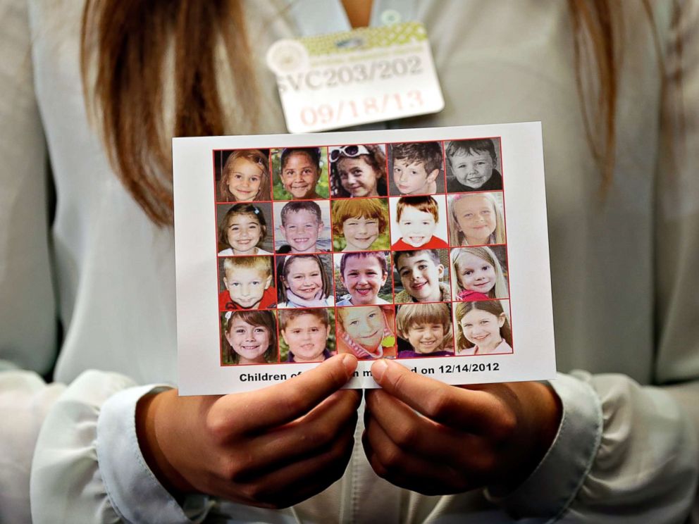 PHOTO: Kyra Murray holds a photo showing victims of the shooting at Sandy Hook Elementary School during a press conference at the U.S. Capitol calling for gun reform legislation, Sept. 18, 2013, in Washington, D.C. 