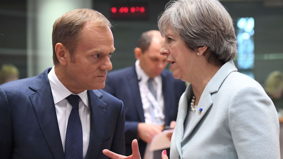 British Prime Minister Theresa May (R) speaks with European Council President Donald Tusk during an EU Eastern Partnership summit with six eastern partner countries at the European Council in Brussels on November 24, 2017