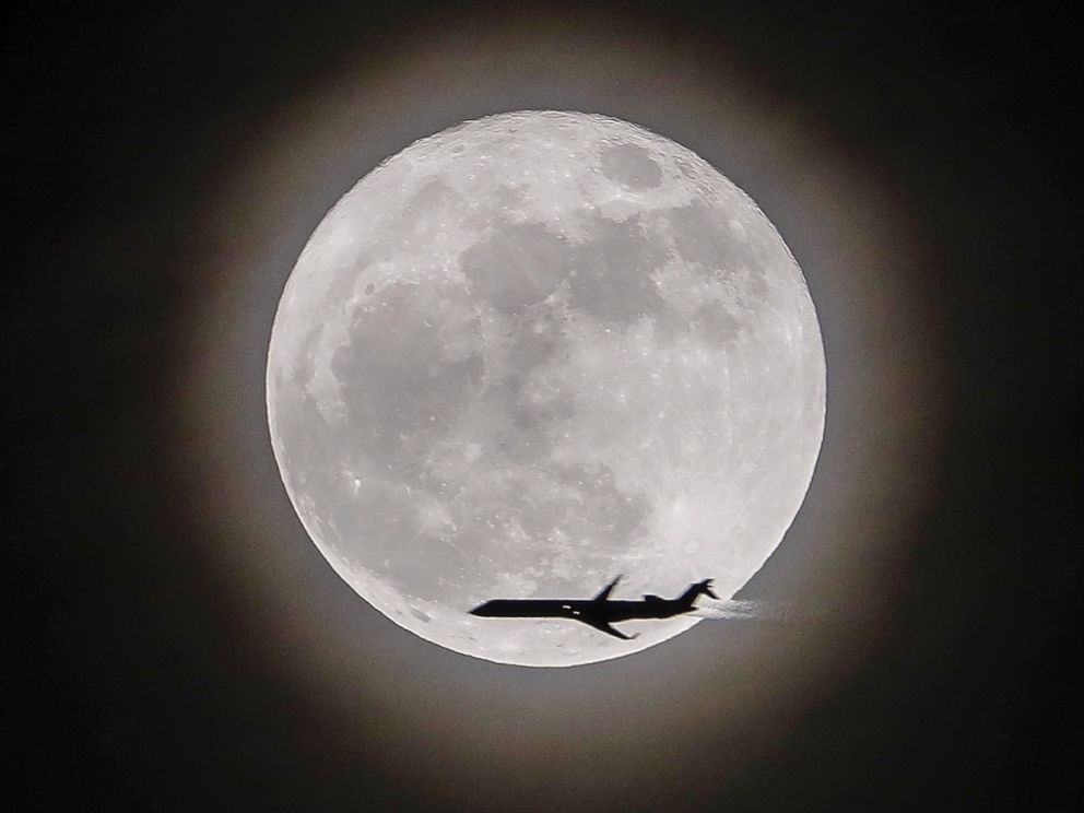 PHOTO: An airplane crosses in front of the moon, a supermoon, in Avondale Estates, Georgia, Dec.3, 2017. 
