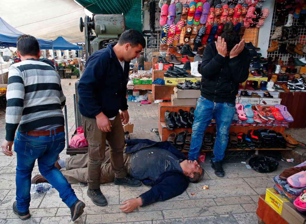 PHOTO: A Palestinian man lies on the ground after being wounded during clashes with Israeli security forces in the city center of the West Bank town of Hebron, Dec. 10, 2017.