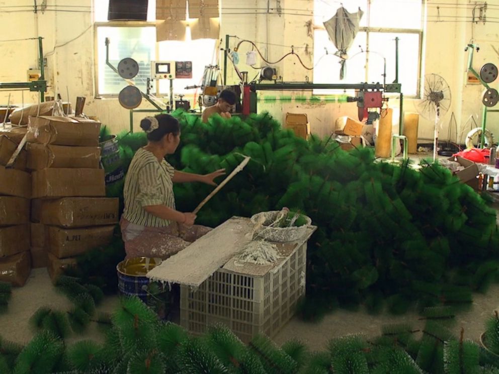PHOTO: A factory worker in Yiwu, China assembles Christmas trees for the upcoming holiday.