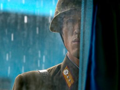 PHOTO: A North Korean soldier looks through the window of the building that sits on the Demilitarized Zone (DMZ) in Panmunjom, South Korea, that separates the two Koreas, July 21, 2010.