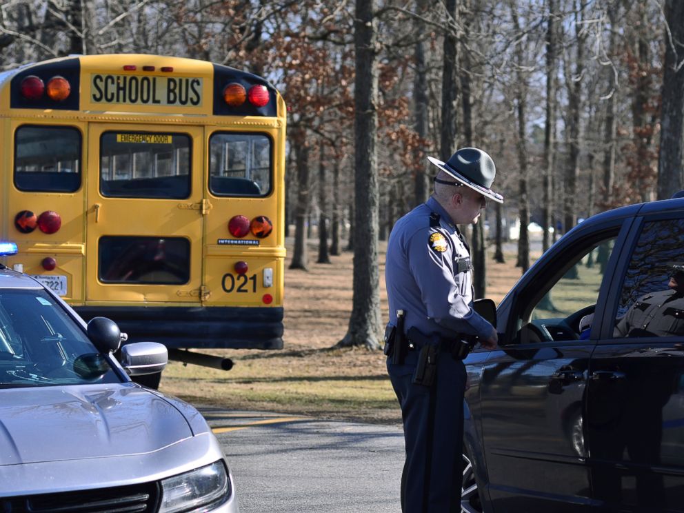 A Kentucky State Police trooper checks with a motorist entering Marshall County High School Wednesday, Jan. 24, 2018, near Benton, Ky. Two students died and another 18 people were injured in a shooting on Tuesday. (AP Photo/Stephen Lance Dennee)