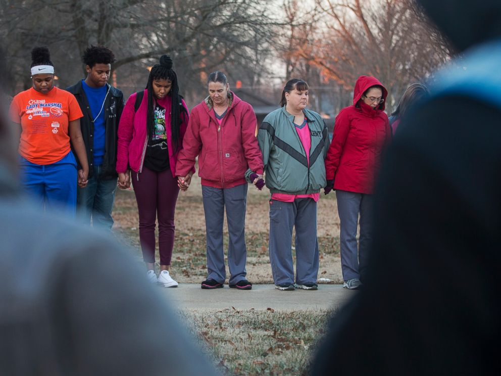 Students and community members hold hands in prayer before classes at Paducah Tilghman High School in Paducah, Ky., Wednesday, Jan. 24, 2018. The gathering was held for the victims of the Marshall County High School shooting on Tuesday. (Ryan Hermens