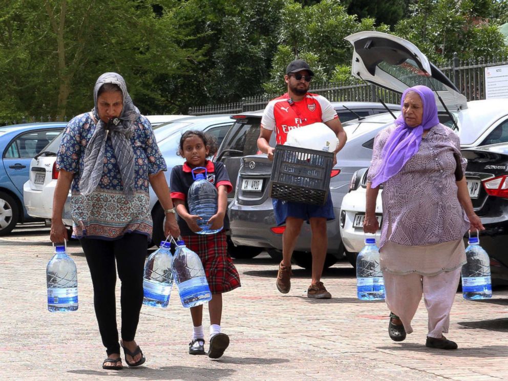 PHOTO: People carry water collected from a natural spring in Cape Town, South Africa, Monday, Jan 22, 2018 as the city suffers from one of the worst droughts in recent history.