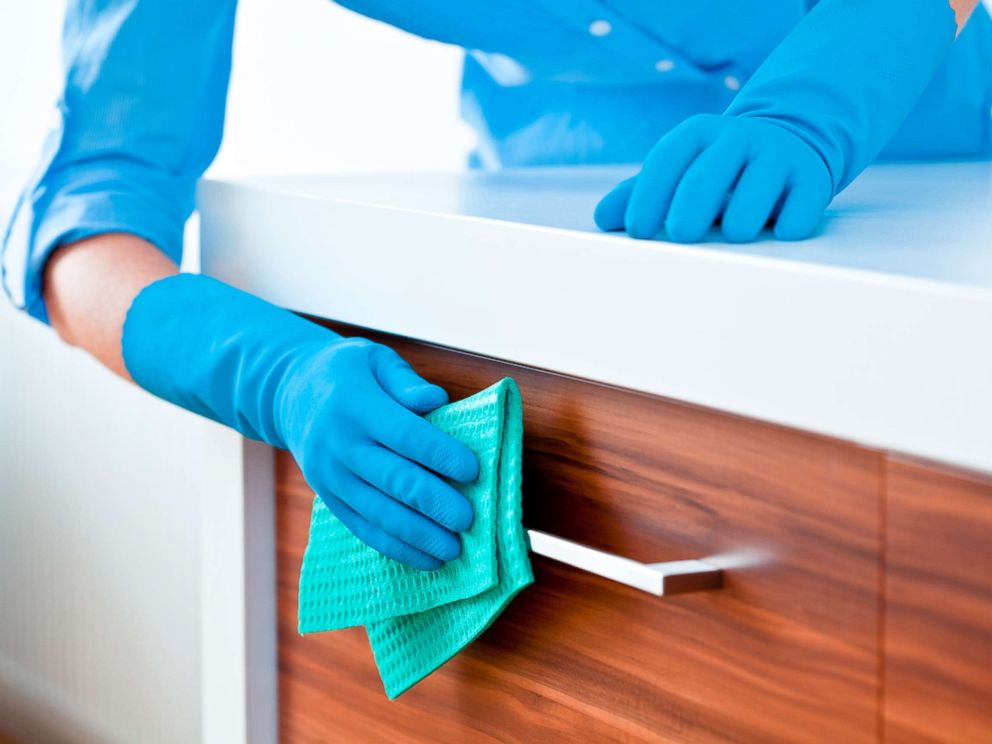 PHOTO: A woman cleaning kitchen cabinets in this undated stock photo.