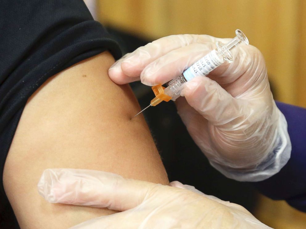 PHOTO: A flu vaccine injection is administered.
