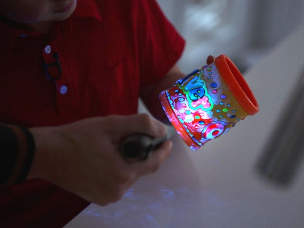 PHOTO: A special UV light shows germs on a cup.