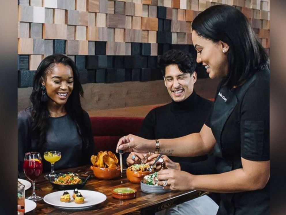 PHOTO: Ayesha Curry attends to guests at International Smoke restaurant in this photo posted on the restaurants Instagram account. 