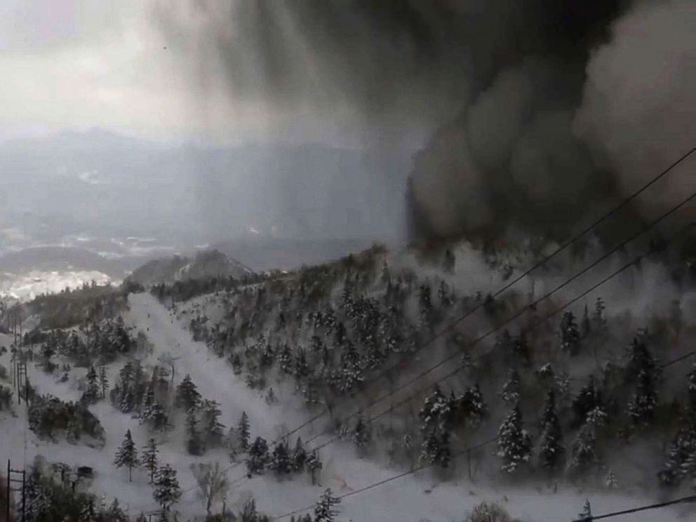 PHOTO: Thick black smoke moves down the snow-covered side of the volcano towards a ski slope after an eruption, in an image from the Kusatsu Mt. Shirane Gondola Unjo camera, Jan. 23, 2018.