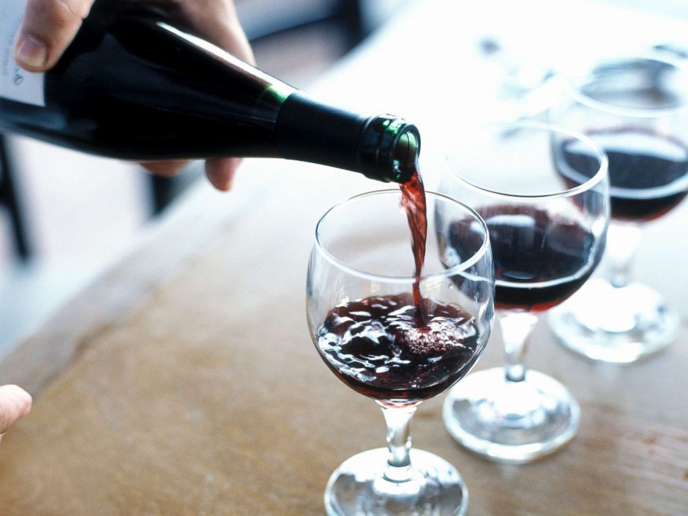 PHOTO: A person is pictured pouring red wine.