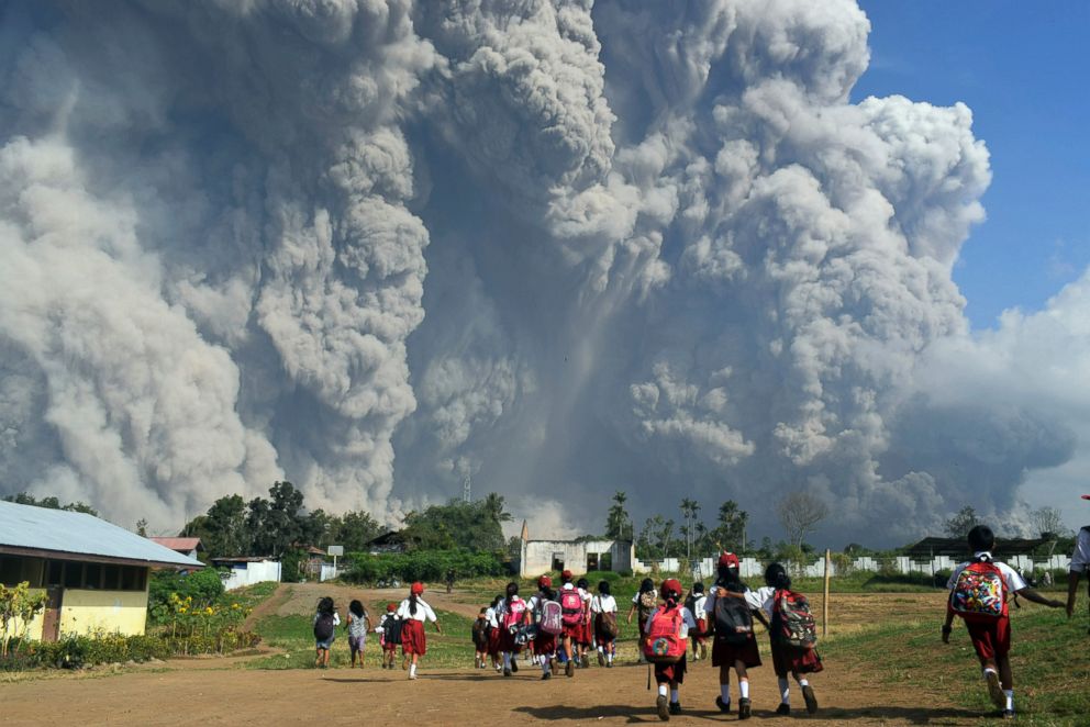 PHOTO: School children walk as Mount Sinabung erupts in Karo, North Sumatra, Indonesia, Feb. 19, 2018.