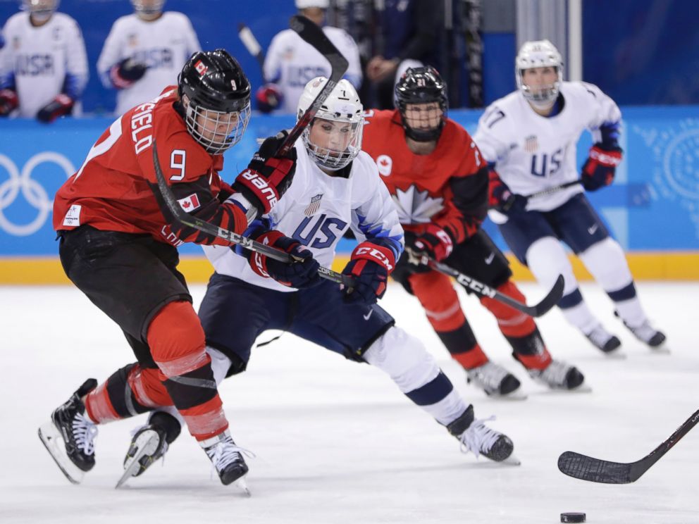 Jennifer Wakefield (9), of Canada, and Monique Lamoureux-Morando (7), of the United States, compete for the puck during the second period of a preliminary round during a womens hockey game at the 2018 Winter Olympics in Gangneung, South Korea, Thurs