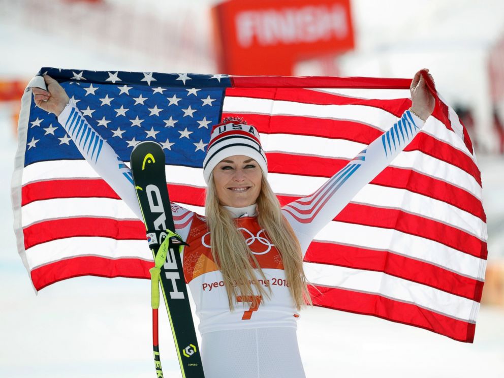 Bronze medal winner Lindsey Vonn, of the United States, celebrates during the flower ceremony for the womens downhill at the 2018 Winter Olympics in Jeongseon, South Korea, Wednesday, Feb. 21, 2018. (AP Photo/Christophe Ena)