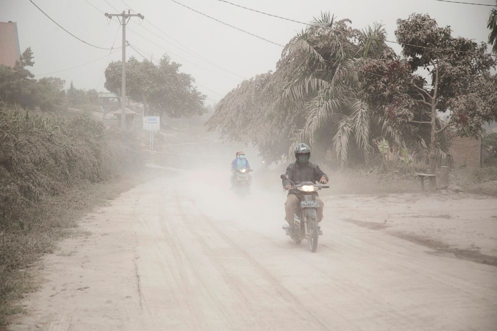 PHOTO: Motorists ride on a road covered in volcanic ash from the eruption of Mount Sinabung in Gurukinayan, North Sumatra, Indonesia, Feb. 19, 2018. 