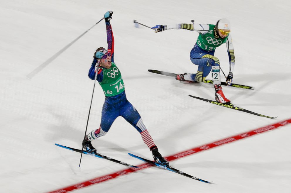 PHOTO: American Jessica Diggins celebrates after crossing the finish line and winning the gold medal past in the womens team sprint freestyle cross-country skiing final, Feb. 21, 2018. Stina Nilsson, of Sweden is in the background.