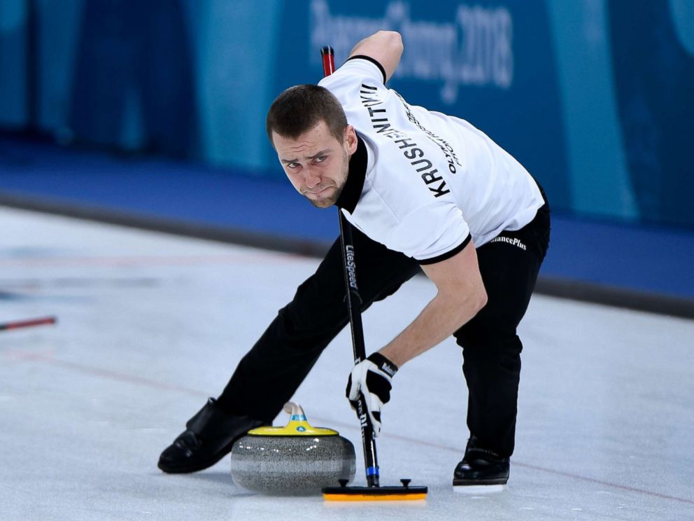 PHOTO: Russias Aleksandr Krushelnitckii brushes the ice surface during the curling mixed doubles round robin session between the U.S. and the Olympic Athletes from Russia during the Pyeongchang 2018 Winter Olympics, Feb. 8, 2018.