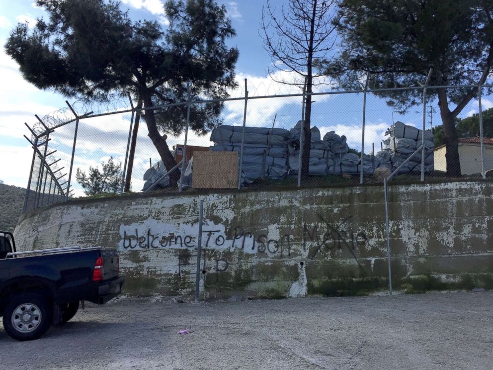 PHOTO: The words Welcome to Prison are spray-painted on the wall that surrounds the Moria refugee camp on the Greek island of Lesbos.