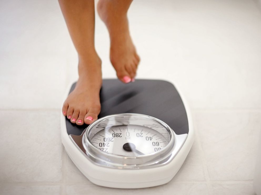 PHOTO: A woman stands on a bathroom scale in this undated stock photo.