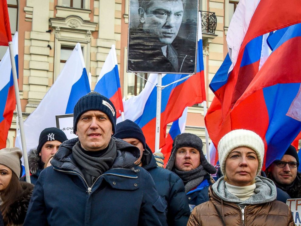 PHOTO: Russian opposition leader Alexey Navalny (L) and his wife Yulia (R) attend an opposition march in memory of murdered Kremlin critic Boris Nemtsov in central Moscow, Feb. 25, 2018. 