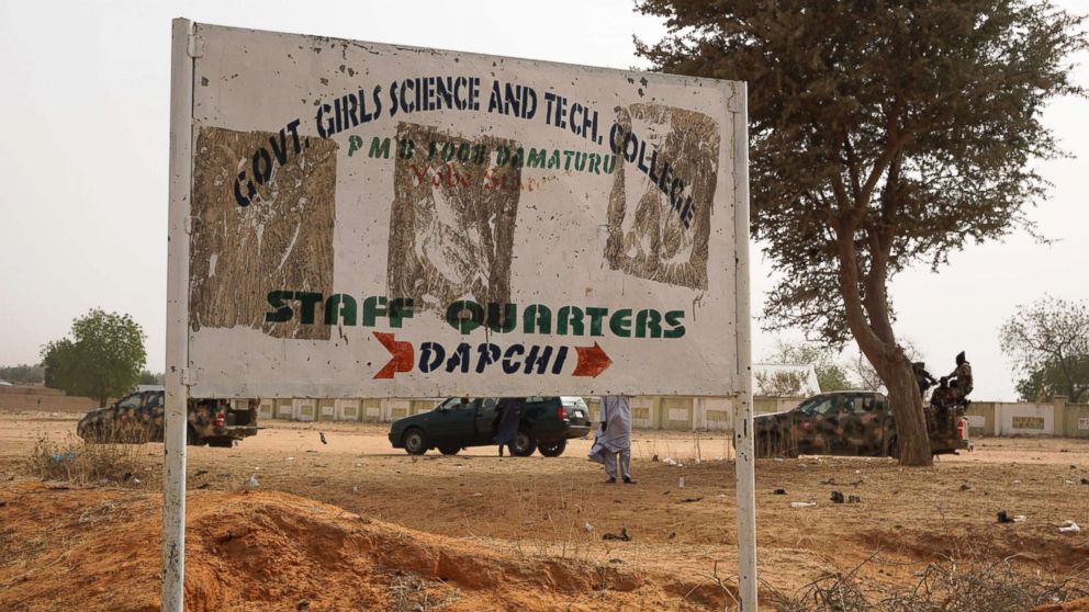 PHOTO: Soldiers (R) drive past a signpost leading to the Government Girls Science and Technical College staff quarters in Dapchi, Nigeria, Feb. 22, 2018. 