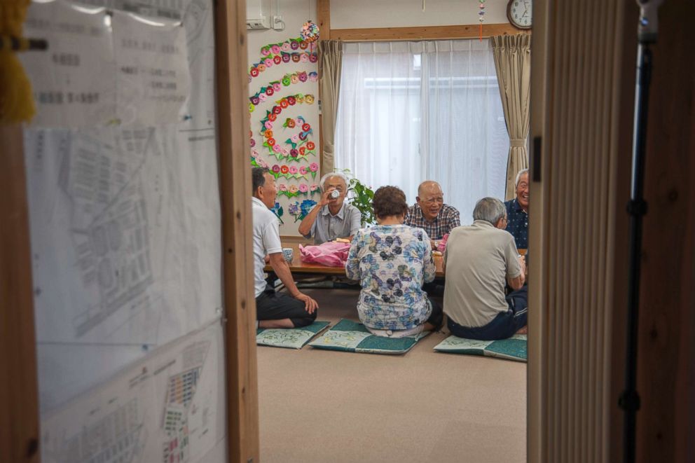 PHOTO: Senior residents chat over a cup of tea after a morning workout at a community center of the Ushigoe Temporary Housing Complex in Minamisoma, Fukushima. About 70 percent of the residents at the complex are at least 60 years old. 